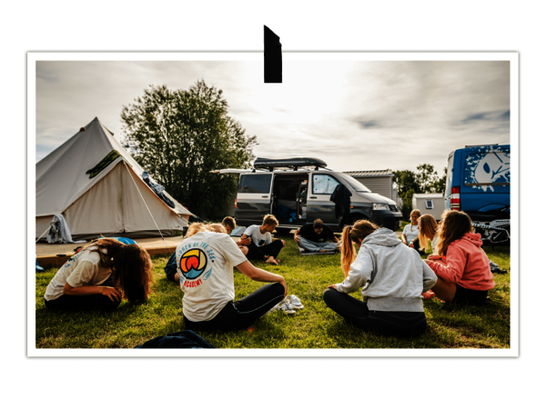 Sportgruppe auf Campingplatz macht Yoga